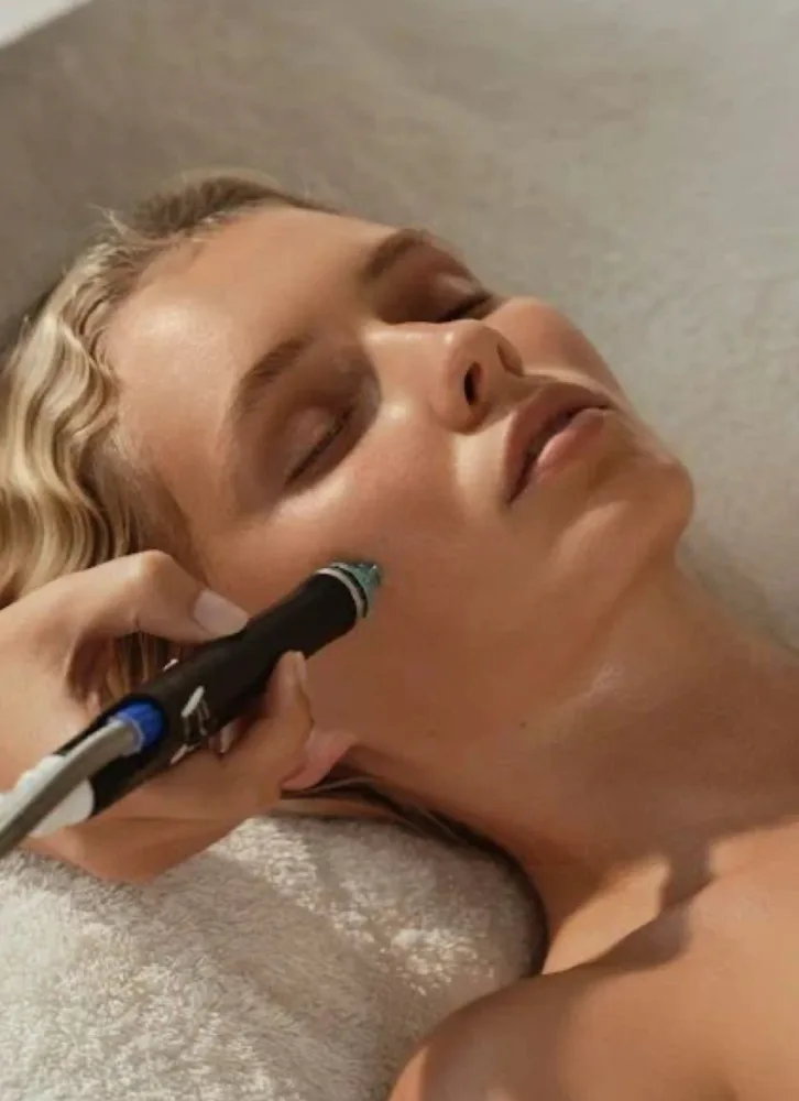 A client enjoying the HydraFacial Luxe 60-minute treatment with the HydraFacial machine for deep skin rejuvenation.